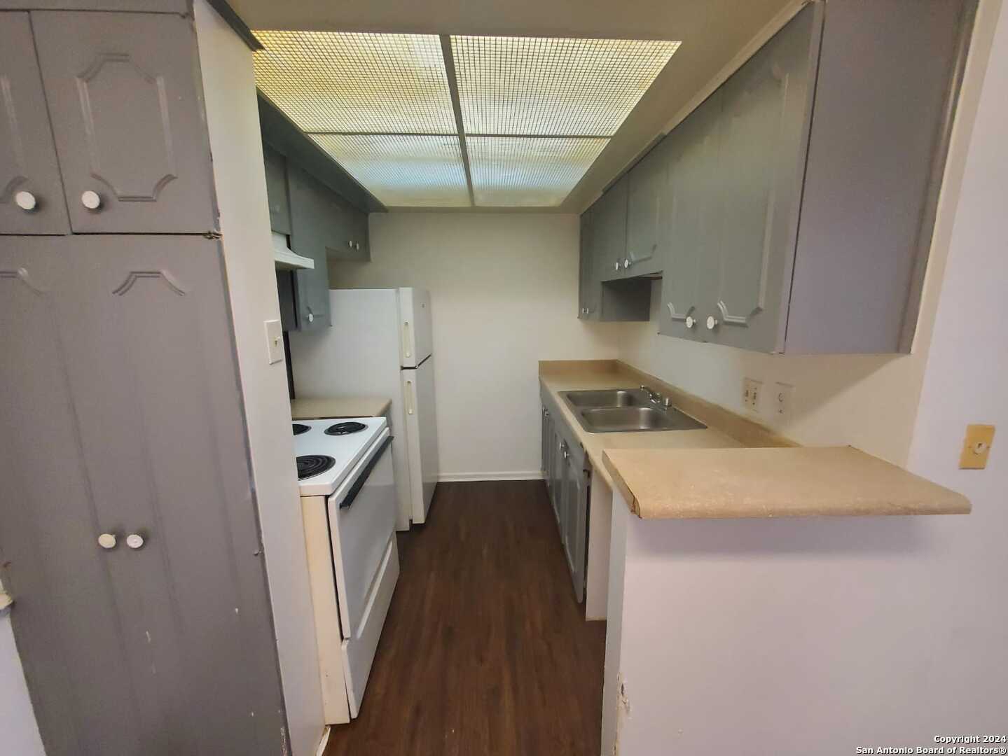 170 De Chantle Road, Unit 208 San Antonio, TX 78201 - Photo 3 of 14 a kitchen with a sink a stove and refrigerator