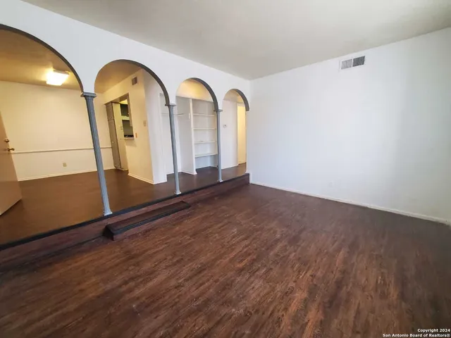 a view of a room with wooden floor
