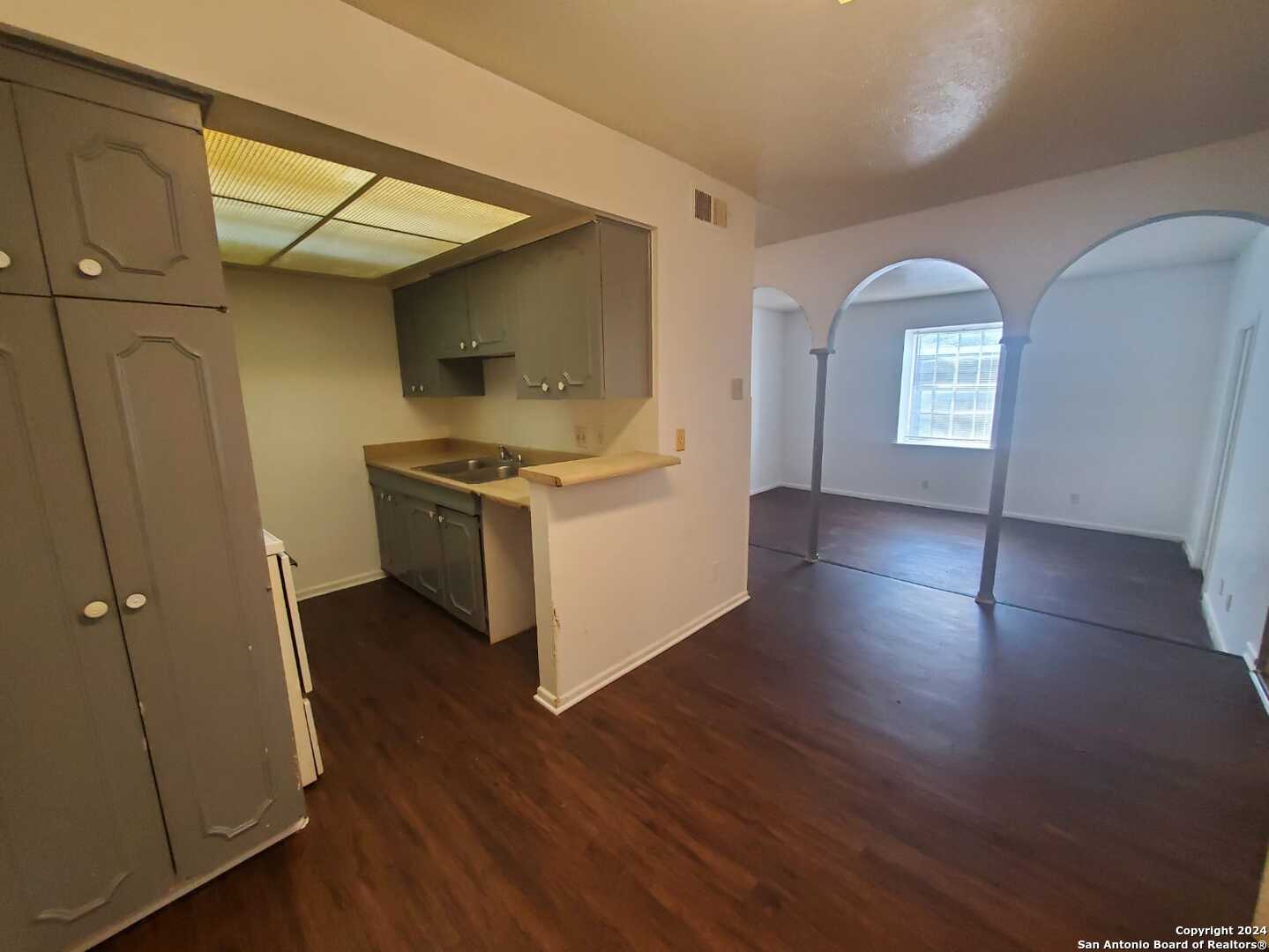 170 De Chantle Road, Unit 208 San Antonio, TX 78201 - Photo 6 of 14 a kitchen with stainless steel appliances granite countertop a stove and a refrigerator