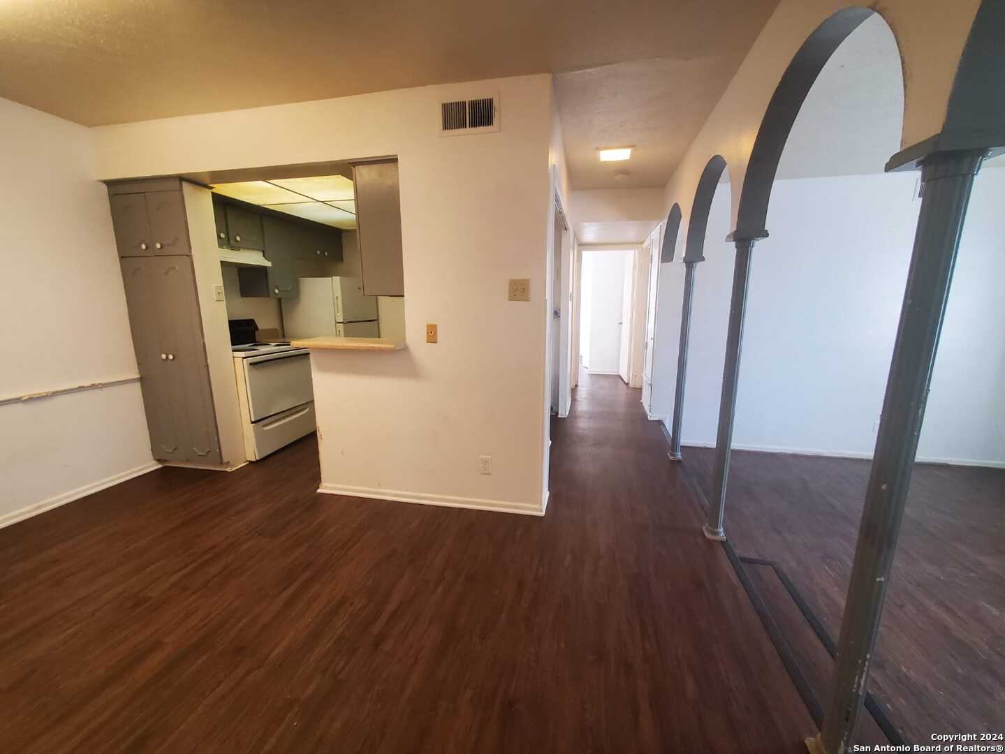 170 De Chantle Road, Unit 208 San Antonio, TX 78201 - Photo 8 of 14 a view of a hallway with wooden floor stairs