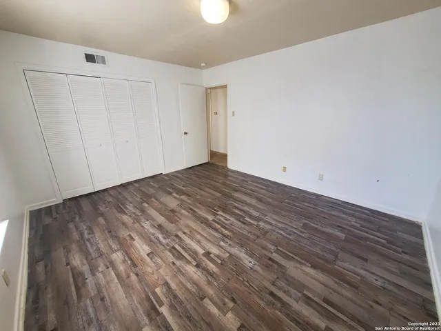 a view of room with wooden floor