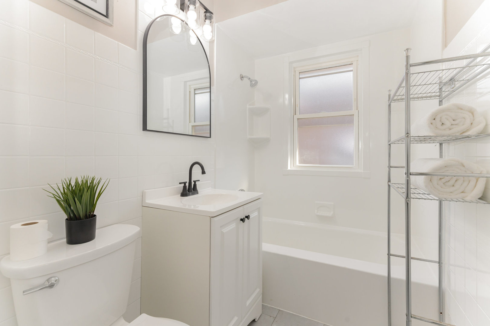 4852 West Hirsch Street Chicago, IL 60651 - Photo 12 of 38 a bathroom with a sink a vanity and a mirror