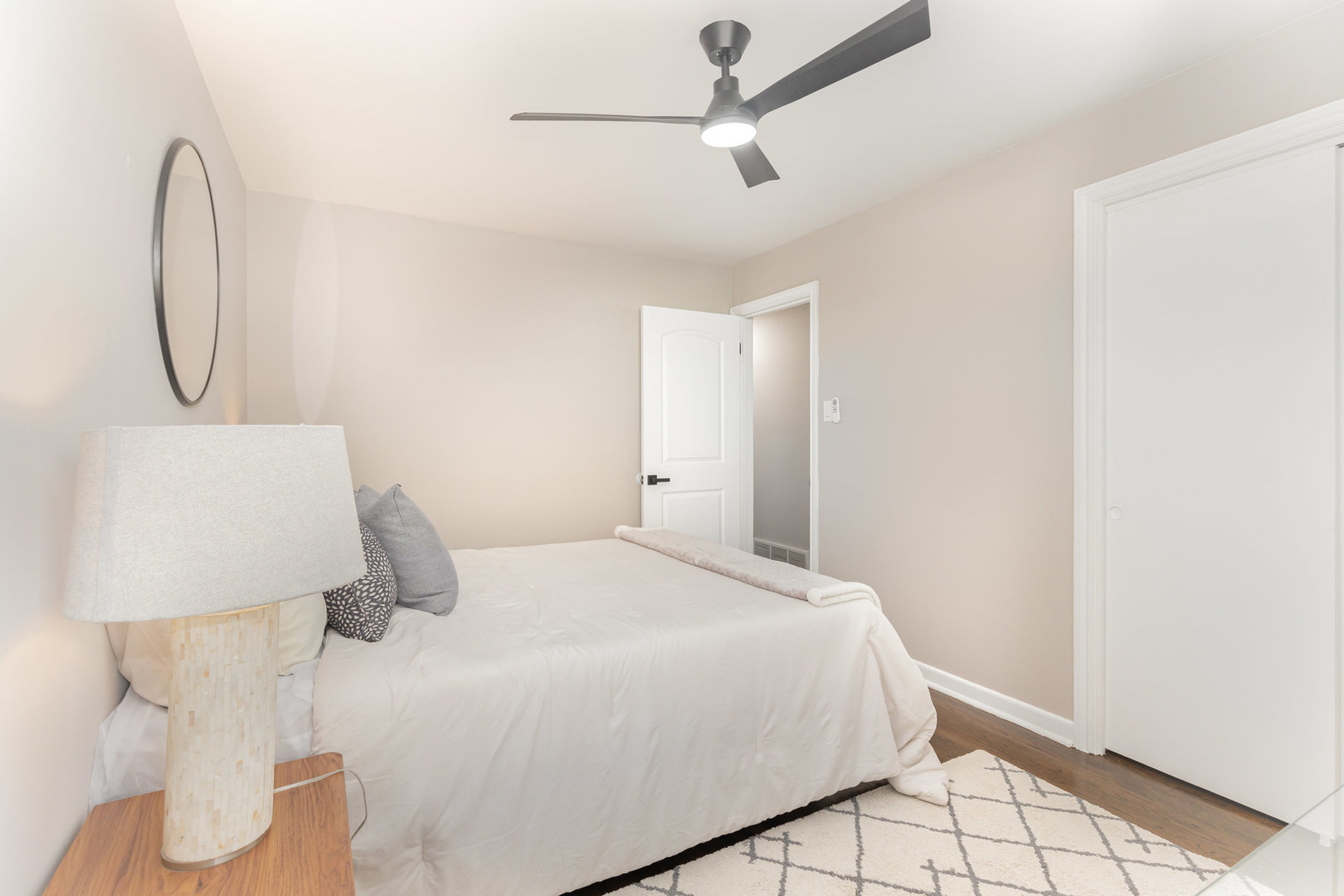 4852 West Hirsch Street Chicago, IL 60651 - Photo 16 of 38 a bedroom with a bed and a chandelier