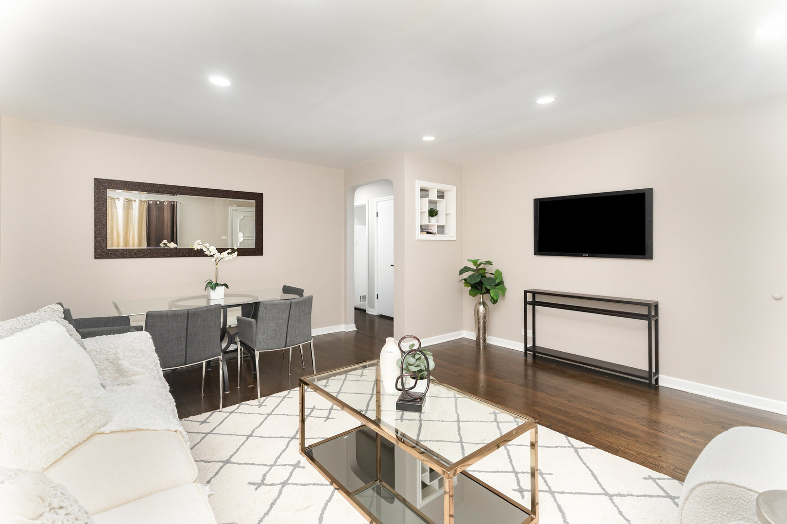 4852 West Hirsch Street Chicago, IL 60651 - Photo 5 of 38 a living room with furniture a flat screen tv and a dining table