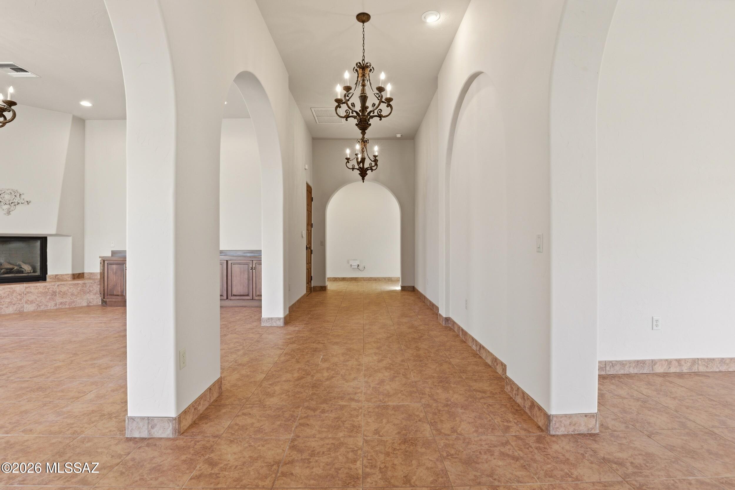 6331 West Trails End Road Tucson, AZ 85745 - Photo 8 of 41 a view of a hallway with a chandelier and entryway