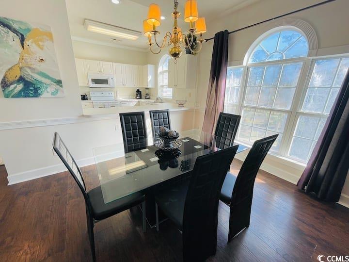 4631 Wild Iris Drive, Unit 301 Myrtle Beach, SC 29577 - Photo 11 of 37 Dining area with a chandelier, dark wood finished floors, and recessed lighting
