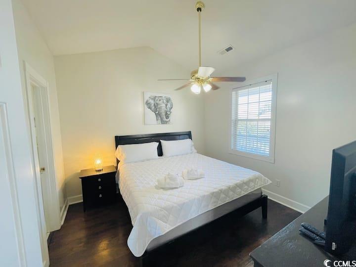4631 Wild Iris Drive, Unit 301 Myrtle Beach, SC 29577 - Photo 17 of 37 Bedroom featuring dark wood finished floors, lofted ceiling, and ceiling fan
