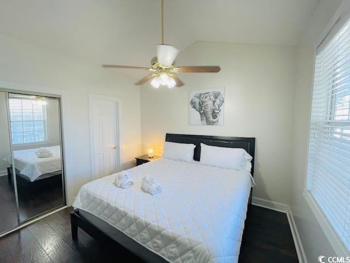 4631 Wild Iris Drive, Unit 301 Myrtle Beach, SC 29577 - Photo 18 of 37 Bedroom featuring a closet, dark wood-type flooring, a ceiling fan, and lofted ceiling