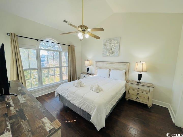 4631 Wild Iris Drive, Unit 301 Myrtle Beach, SC 29577 - Photo 22 of 37 Bedroom with dark wood-style flooring, vaulted ceiling, and ceiling fan