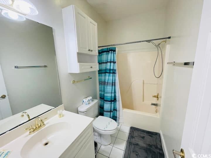 4631 Wild Iris Drive, Unit 301 Myrtle Beach, SC 29577 - Photo 29 of 37 Full bath with vanity, shower / bath combo, and light tile patterned flooring