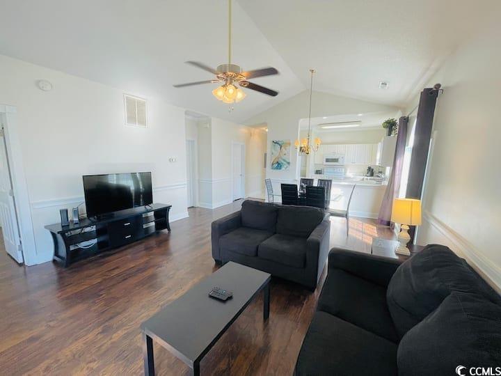 4631 Wild Iris Drive, Unit 301 Myrtle Beach, SC 29577 - Photo 3 of 37 Living room with dark wood-type flooring, vaulted ceiling, and ceiling fan