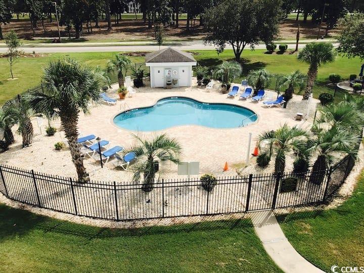 4631 Wild Iris Drive, Unit 301 Myrtle Beach, SC 29577 - Photo 34 of 37 Community pool featuring a patio