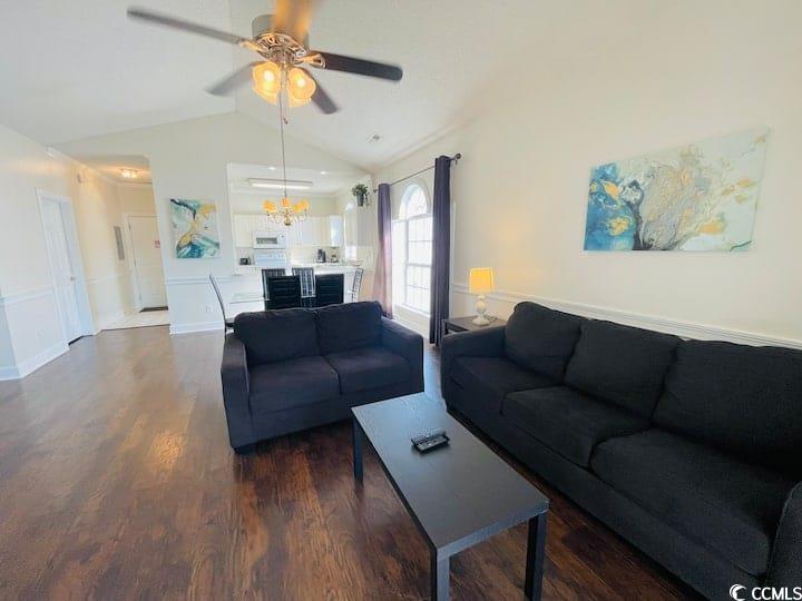4631 Wild Iris Drive, Unit 301 Myrtle Beach, SC 29577 - Photo 8 of 37 Living area with lofted ceiling, dark wood finished floors, and ceiling fan