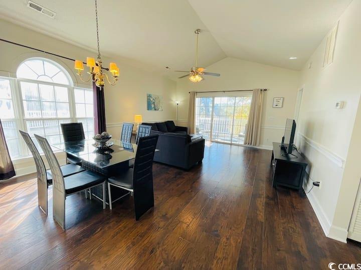4631 Wild Iris Drive, Unit 301 Myrtle Beach, SC 29577 - Photo 9 of 37 Dining area with lofted ceiling, dark wood-style floors, ceiling fan, and a chandelier
