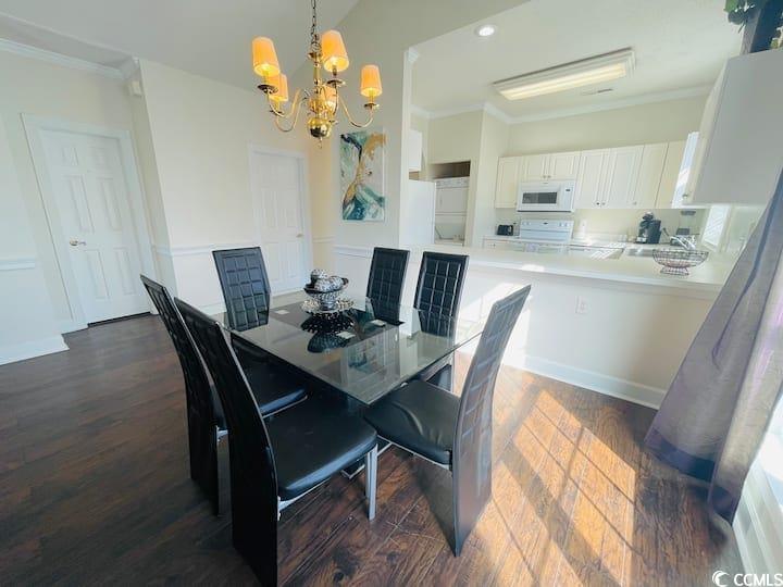 4631 Wild Iris Drive, Unit 301 Myrtle Beach, SC 29577 - Photo 10 of 37 Dining space with crown molding, dark wood finished floors, a chandelier, and recessed lighting