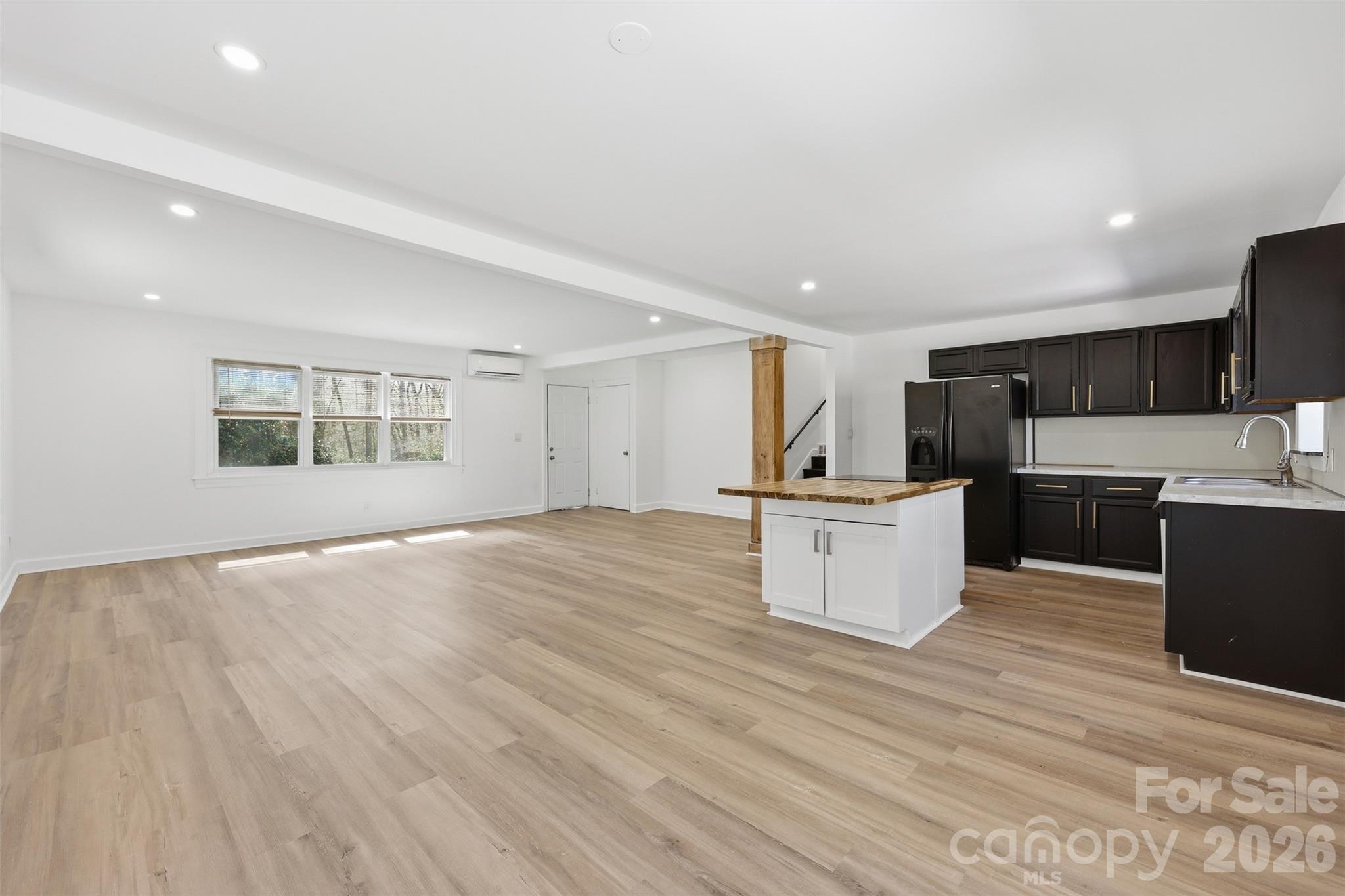 4920 Bright Road Charlotte, NC 28214 - Photo 11 of 46 a view of kitchen with kitchen island stainless steel appliances wooden cabinets and window