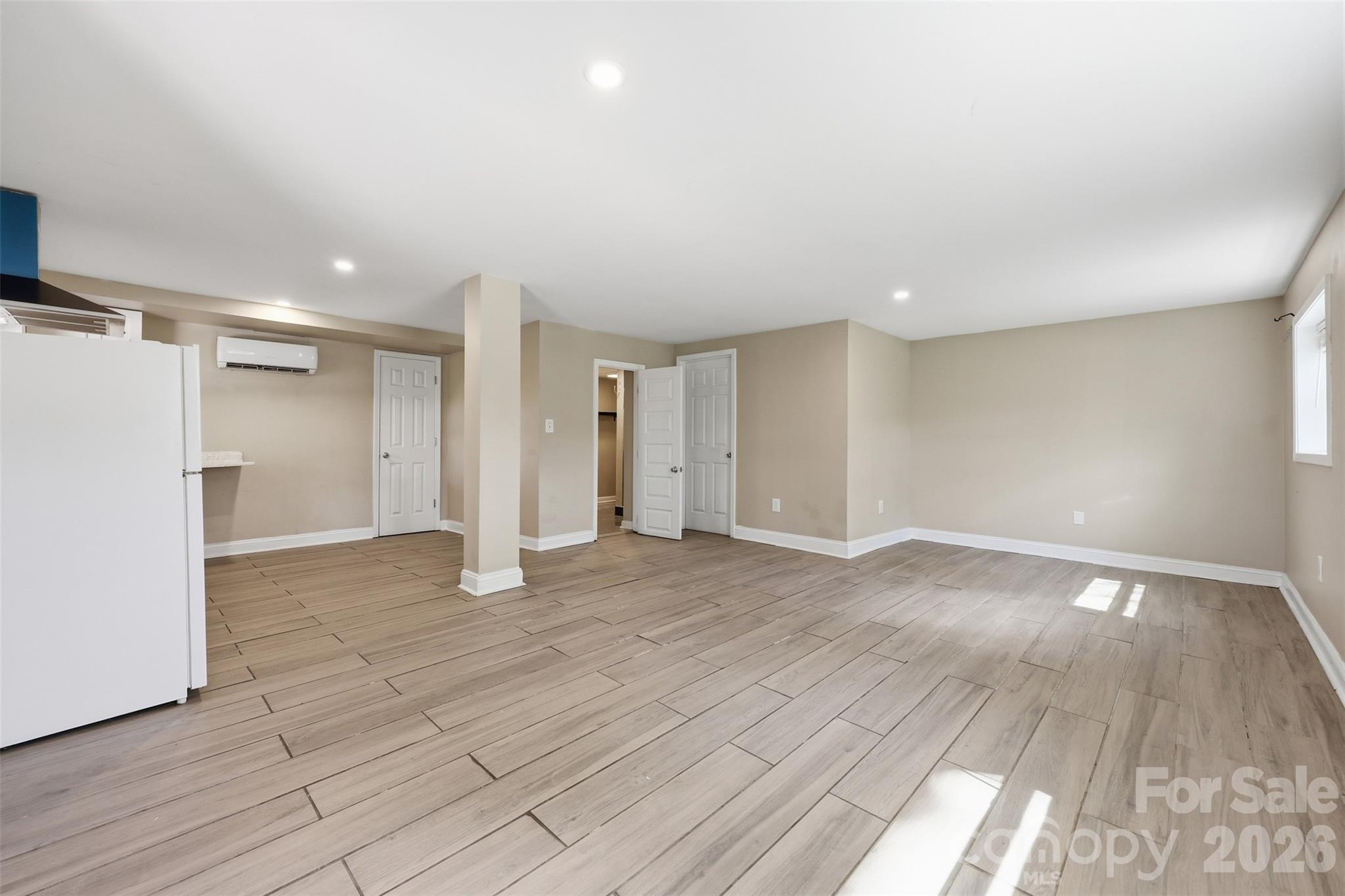 4920 Bright Road Charlotte, NC 28214 - Photo 17 of 46 a view of an empty room with wooden floor and a window
