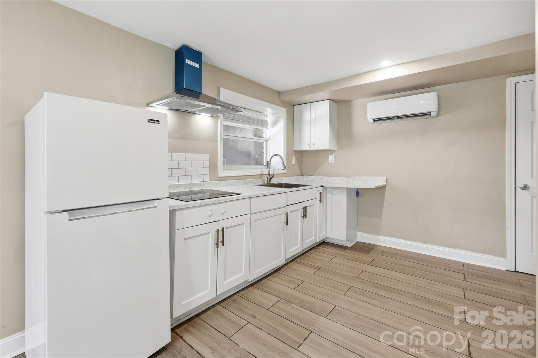 4920 Bright Road Charlotte, NC 28214 - Photo 19 of 46 a kitchen with a sink stainless steel appliances a refrigerator and cabinets
