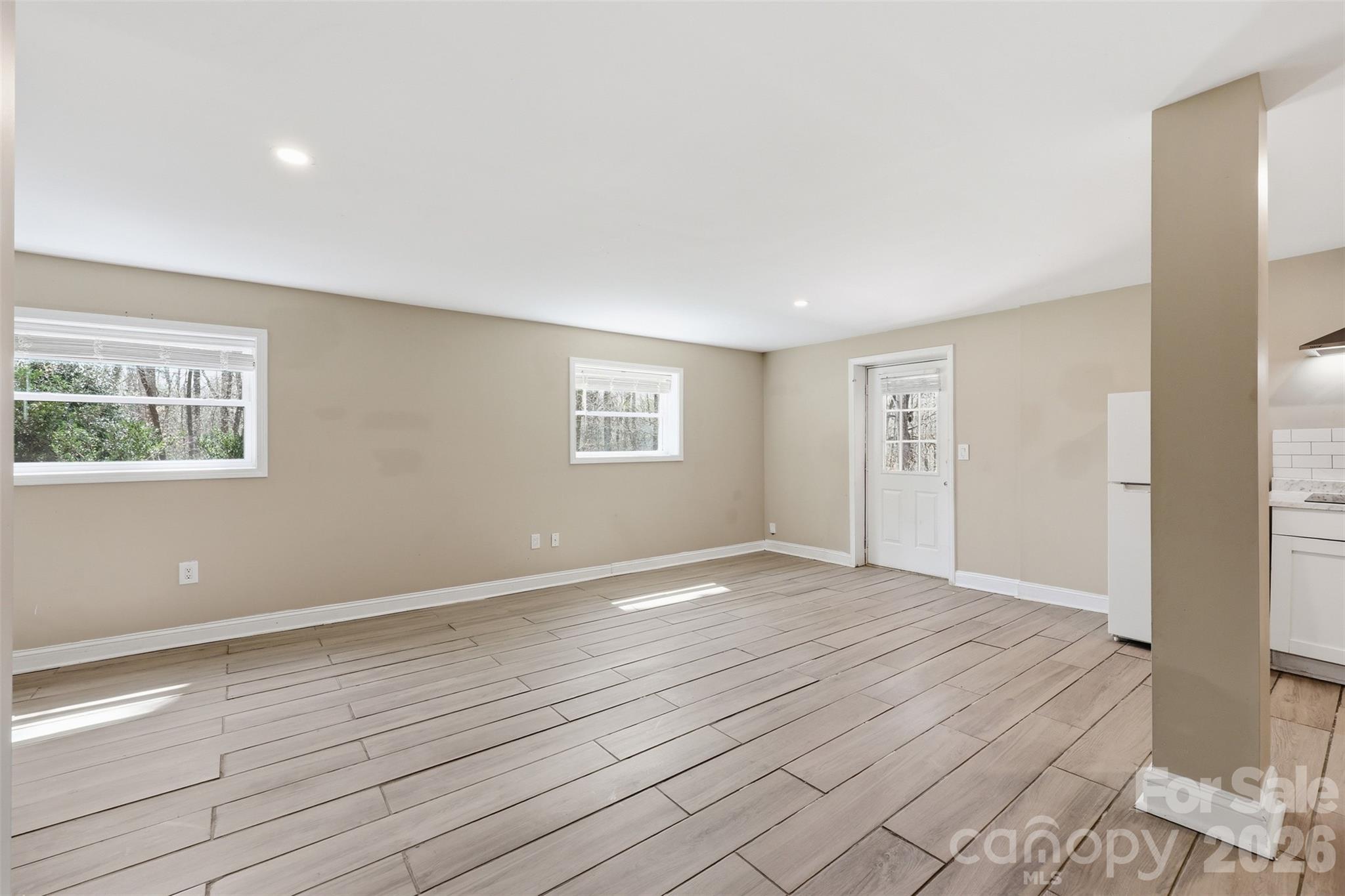 4920 Bright Road Charlotte, NC 28214 - Photo 21 of 46 a view of an empty room with wooden floor and a window