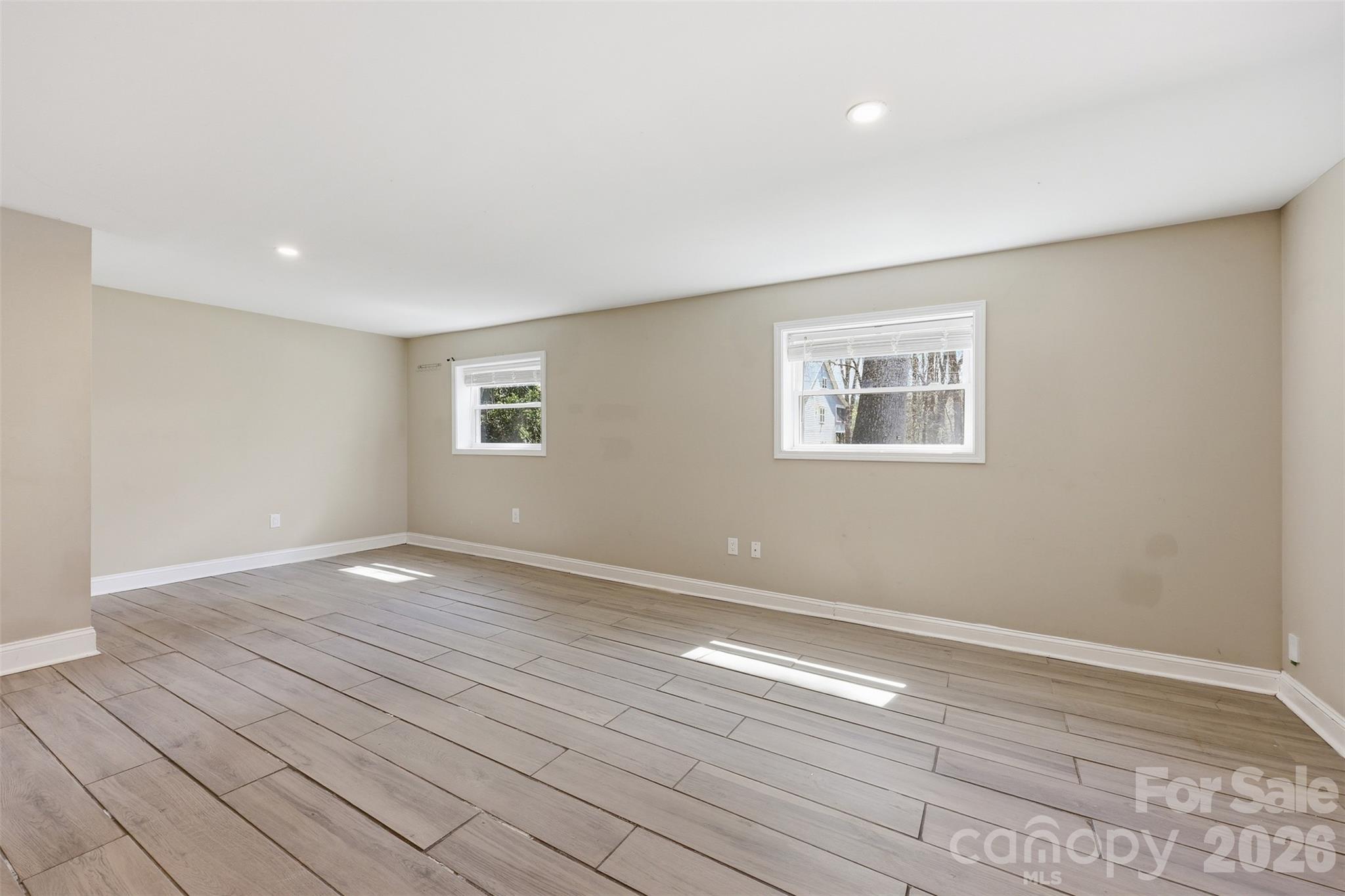 4920 Bright Road Charlotte, NC 28214 - Photo 22 of 46 a view of empty room with wooden floor and fan