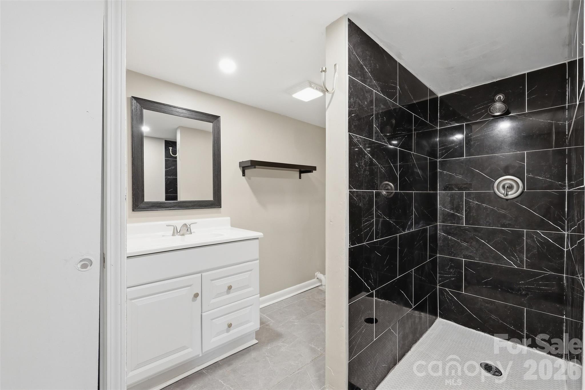 4920 Bright Road Charlotte, NC 28214 - Photo 24 of 46 a bathroom with a shower a toilet and sink