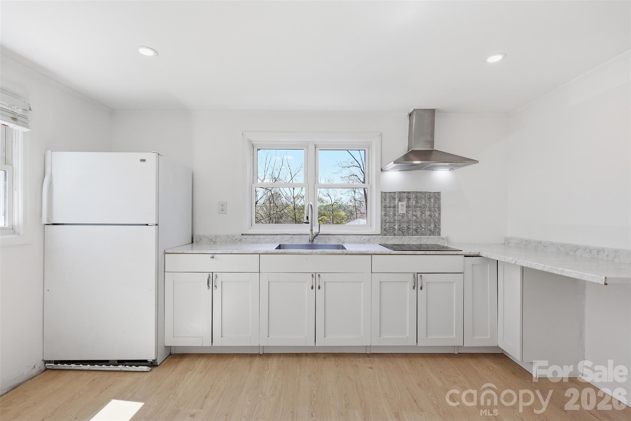4920 Bright Road Charlotte, NC 28214 - Photo 27 of 46 a kitchen with white cabinets and refrigerator
