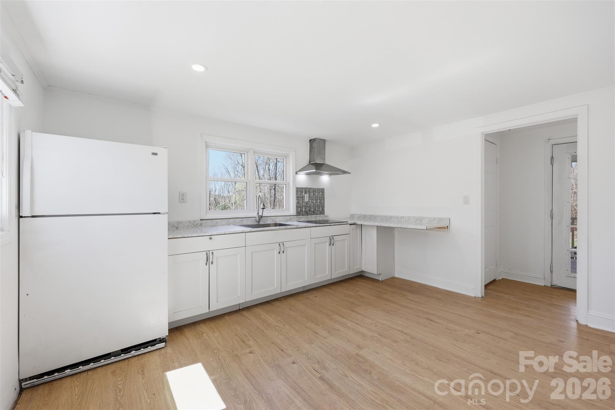 4920 Bright Road Charlotte, NC 28214 - Photo 28 of 46 a kitchen with white cabinets and refrigerator