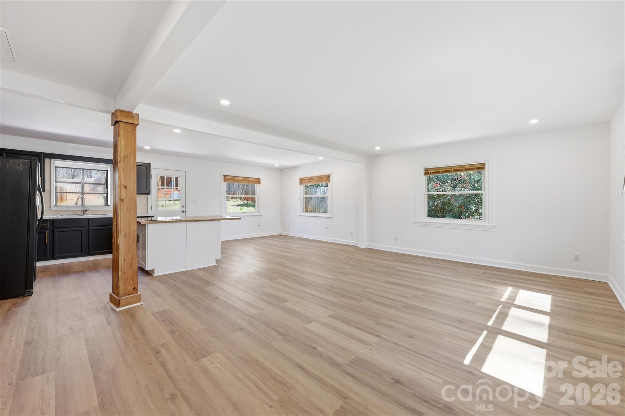 4920 Bright Road Charlotte, NC 28214 - Photo 3 of 46 a view of a kitchen with wooden floor and windows