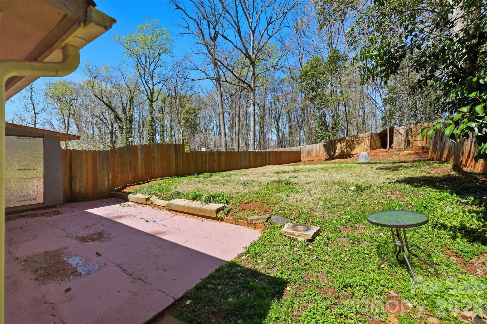 4920 Bright Road Charlotte, NC 28214 - Photo 46 of 46 a view of a backyard with table and chairs with wooden fence and plants