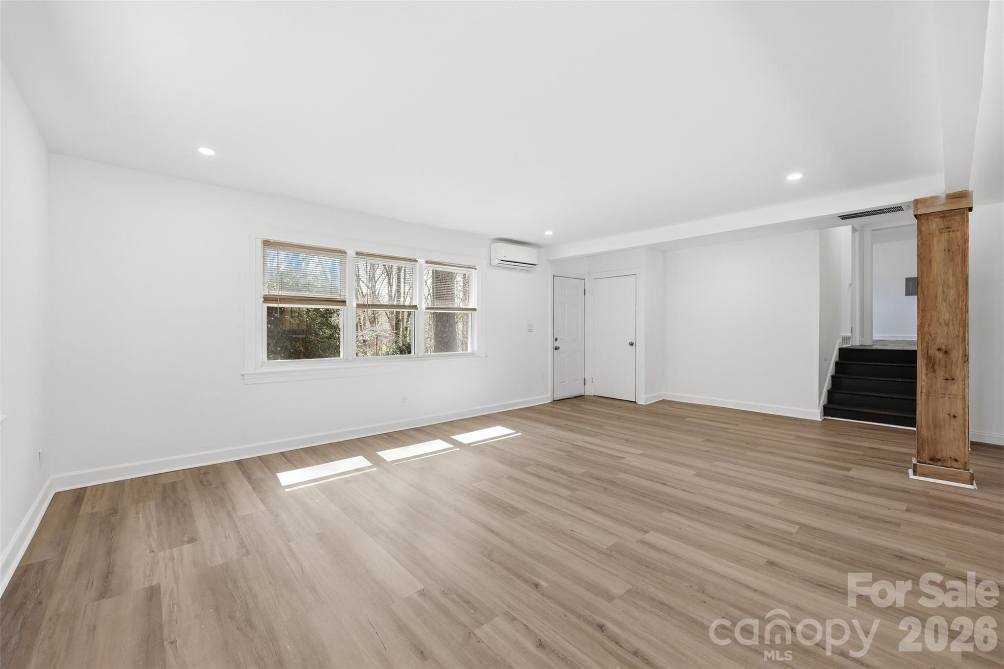 4920 Bright Road Charlotte, NC 28214 - Photo 5 of 46 a view of an empty room with wooden floor and a window