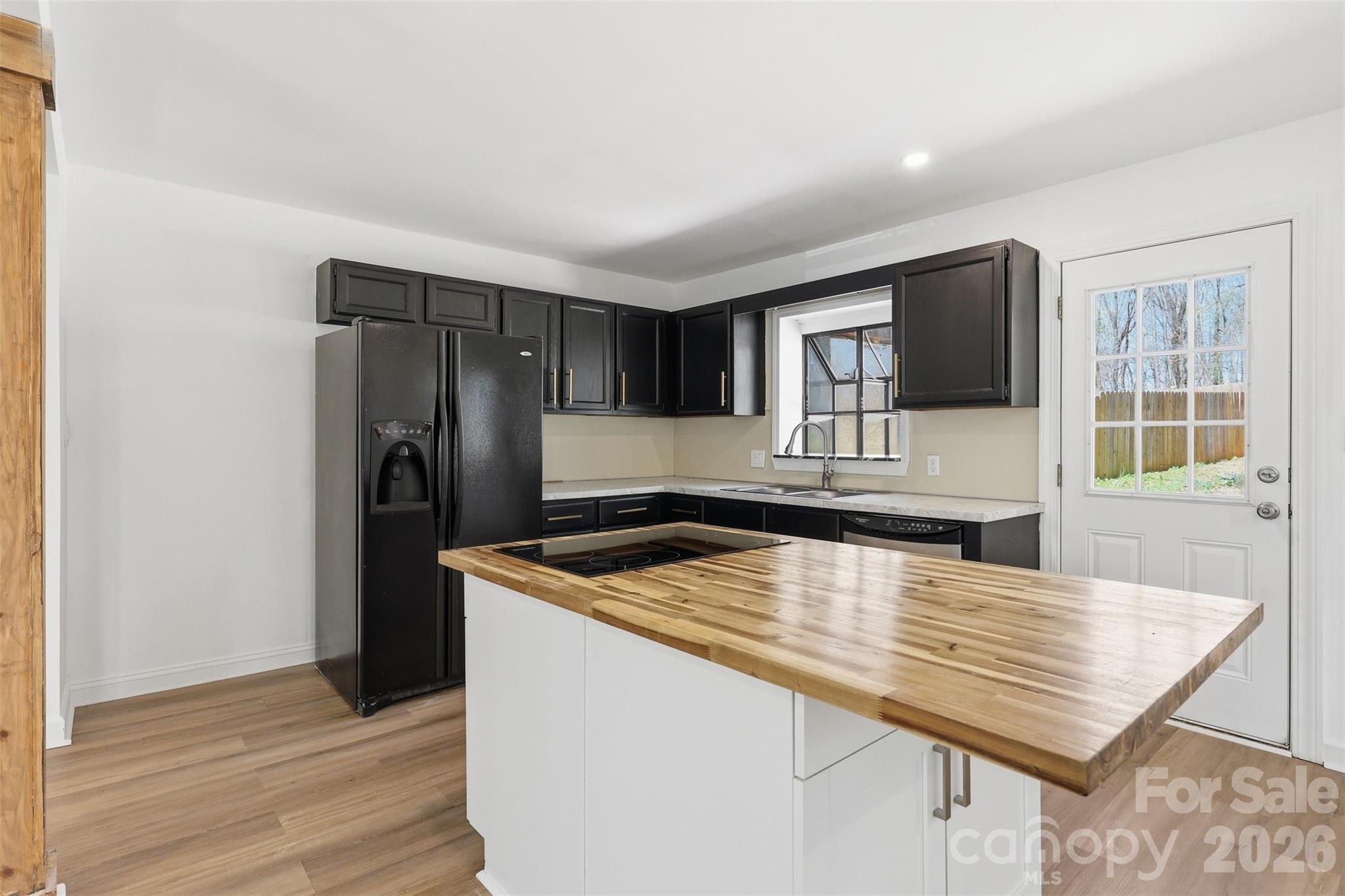 4920 Bright Road Charlotte, NC 28214 - Photo 6 of 46 a kitchen with stainless steel appliances granite countertop a sink refrigerator and microwave