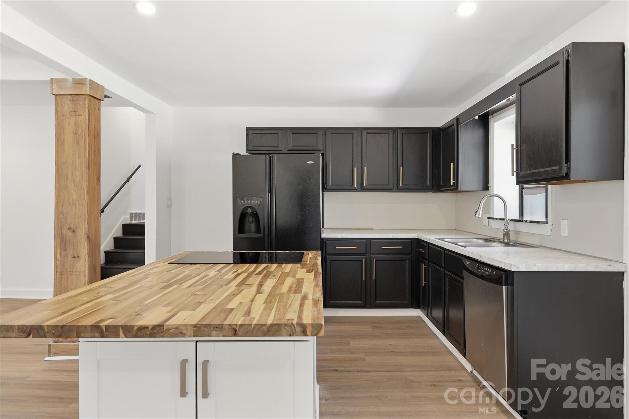 4920 Bright Road Charlotte, NC 28214 - Photo 7 of 46 a kitchen with kitchen island granite countertop a sink stainless steel appliances and cabinets
