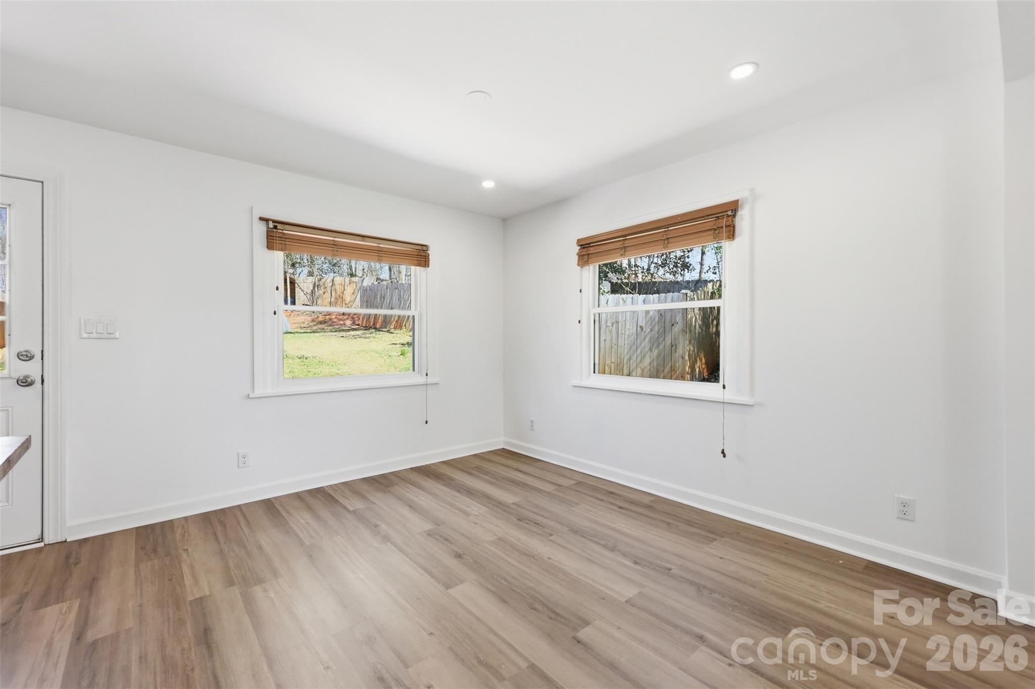 4920 Bright Road Charlotte, NC 28214 - Photo 10 of 46 an empty room with wooden floor and windows