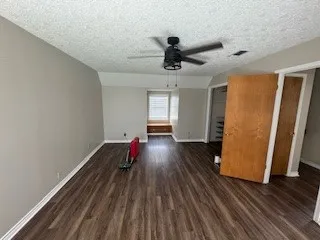 a backyard of a house with barbeque oven table and chairs