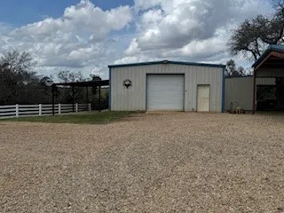 a room with wooden floors pool table and chairs