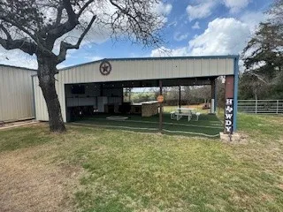 a view of backyard with wooden fence