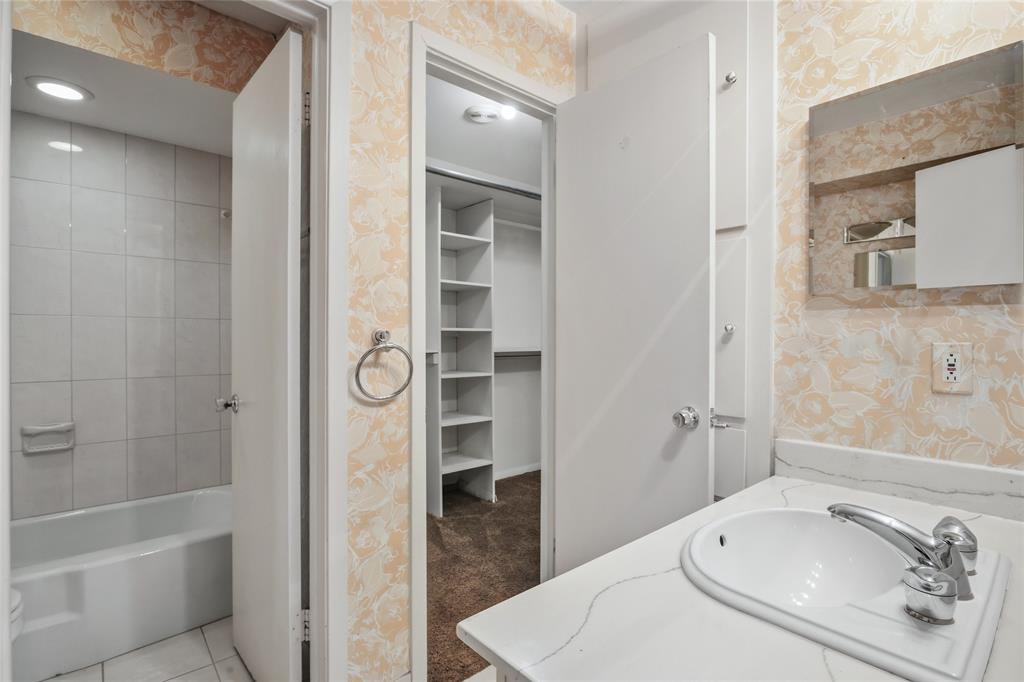 15721 Mapleview Circle Dallas, TX 75248 - Photo 26 of 40 a bathroom with a bathtub and a shower