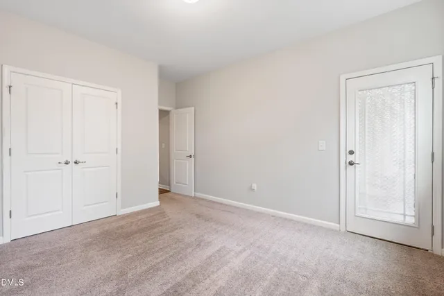 a view of an empty room and closet area