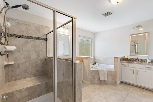 a bathroom with a double vanity sink toilet and shower
