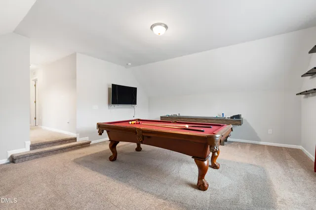 a room with a pool table and a chandelier
