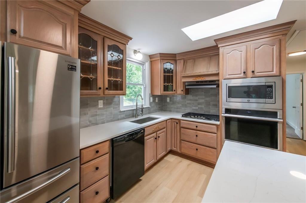 3819 Mason Creek Road Winston, GA 30187 - Photo 13 of 54 a kitchen with granite countertop stainless steel appliances a refrigerator stove and sink