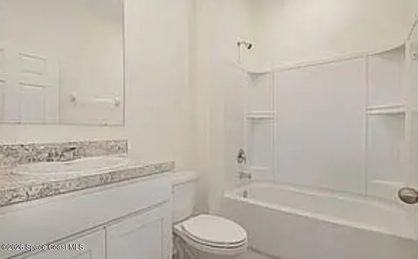 a bathroom with a sink toilet vanity and shower