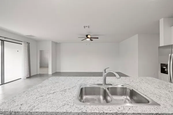 a kitchen with a sink and granite top