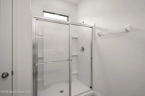 a bathroom with a glass shower door