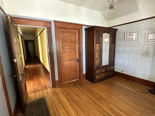 a view of an entryway with wooden floor