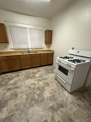 a kitchen with stainless steel appliances a stove a microwave and a sink