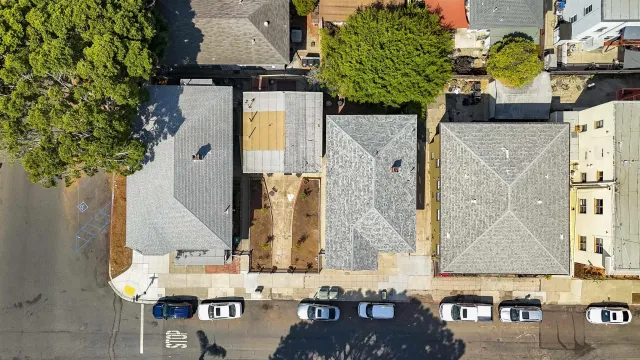 an aerial view of residential houses with outdoor space
