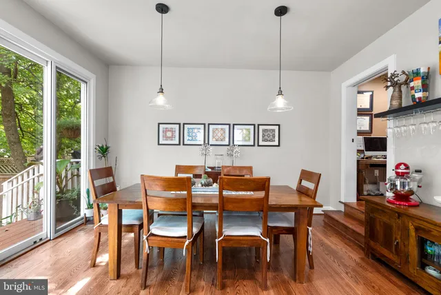 a dining room with furniture a rug and wooden floor