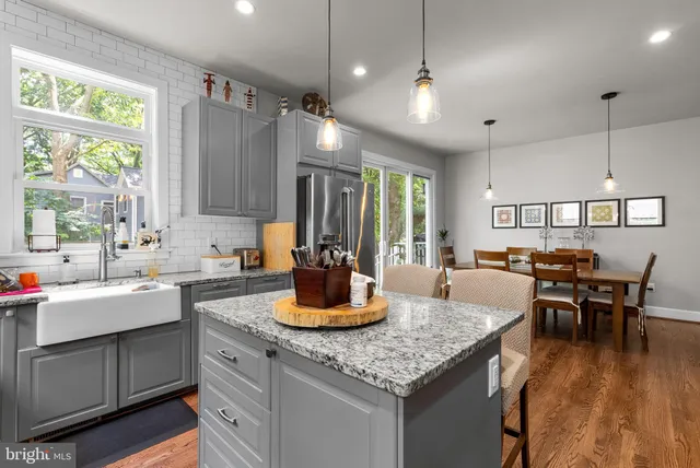a kitchen with a table chairs stove and cabinets