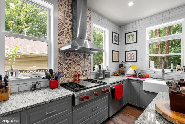 a kitchen with a sink stove and cabinets